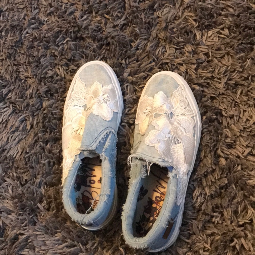 blue slip on shoes with lace flowers.